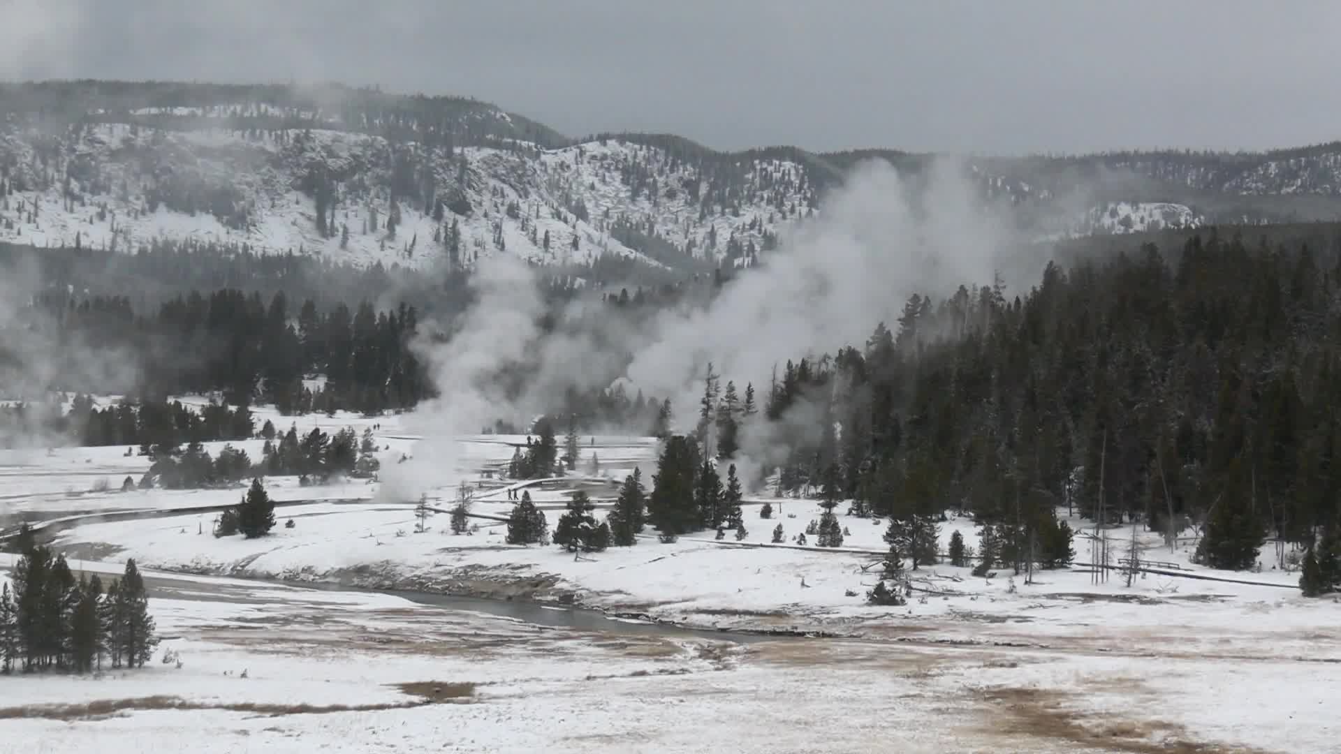 View of Old Faithful geyser from a distance